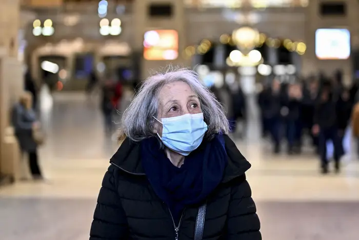 People wear masks in Grand Central Terminal on Dec. 12, 2022 after New York City health officials issue an advisory about COVID-19, flu, and RSV cases.